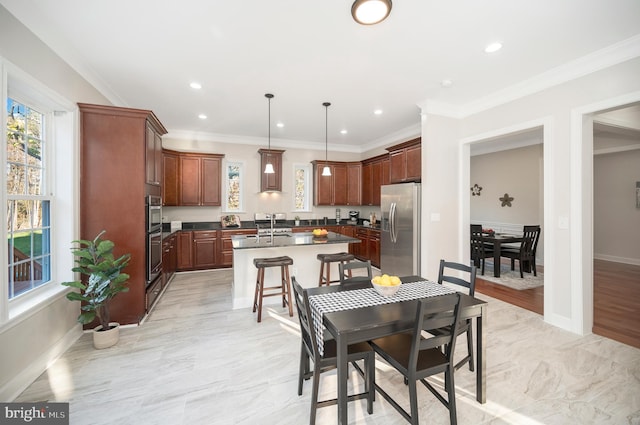 dining space featuring crown molding