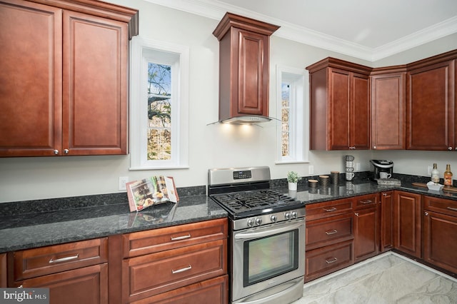 kitchen featuring stainless steel gas stove, dark stone countertops, crown molding, and custom exhaust hood