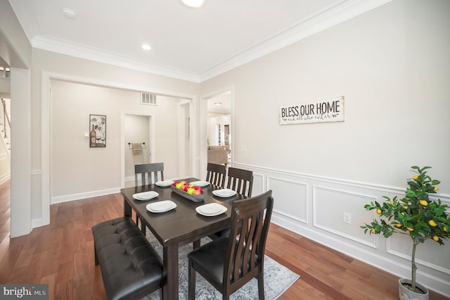 dining space featuring dark hardwood / wood-style floors and ornamental molding