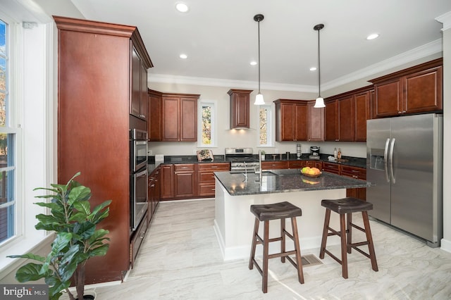 kitchen featuring stainless steel appliances, premium range hood, crown molding, decorative light fixtures, and a kitchen island with sink