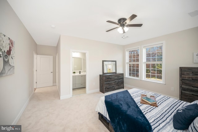 bedroom with connected bathroom, ceiling fan, and light carpet