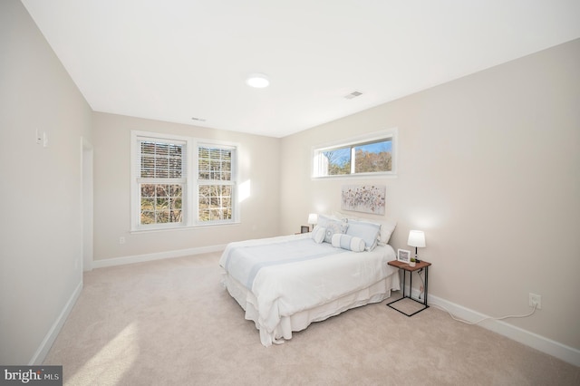 bedroom featuring light carpet