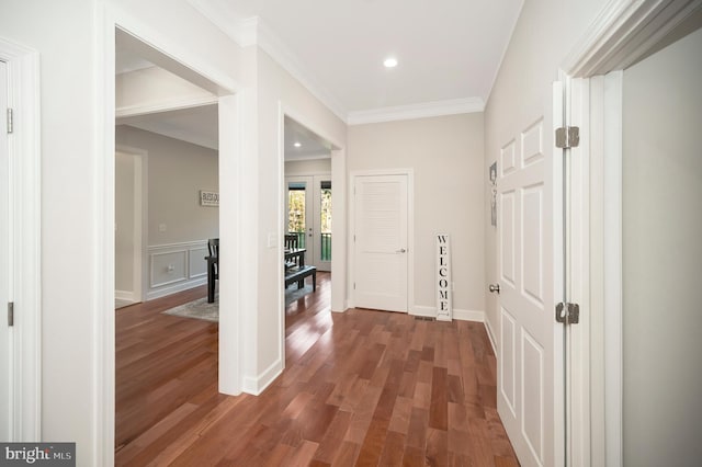 hall with crown molding, french doors, and dark wood-type flooring