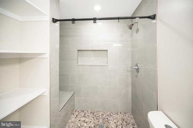 bathroom with a tile shower