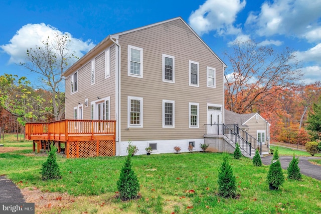 view of home's exterior with a yard and a wooden deck