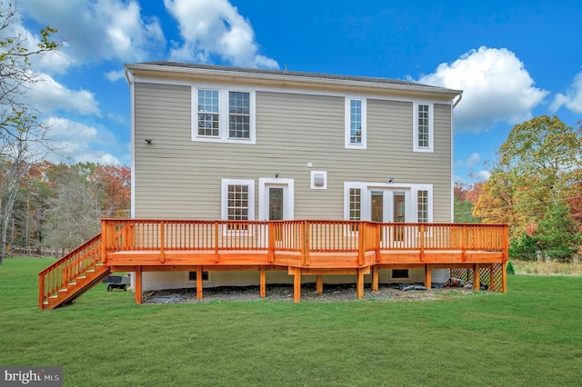 back of house featuring a lawn, a deck, and french doors