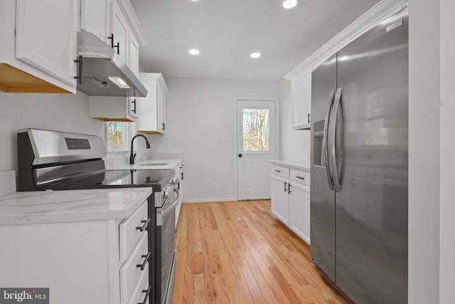 kitchen with white cabinetry, sink, light wood-type flooring, and appliances with stainless steel finishes