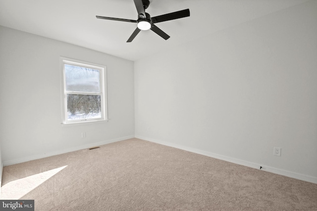 carpeted spare room with ceiling fan