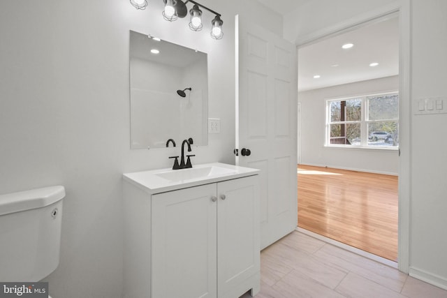 bathroom featuring tile patterned flooring, vanity, and toilet