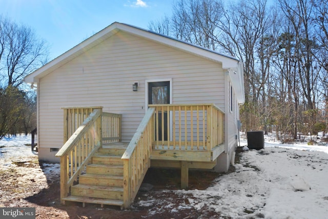 snow covered house with central AC