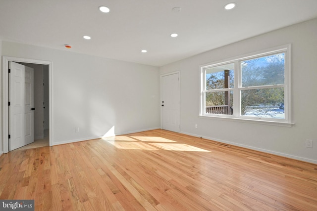 empty room with light hardwood / wood-style flooring