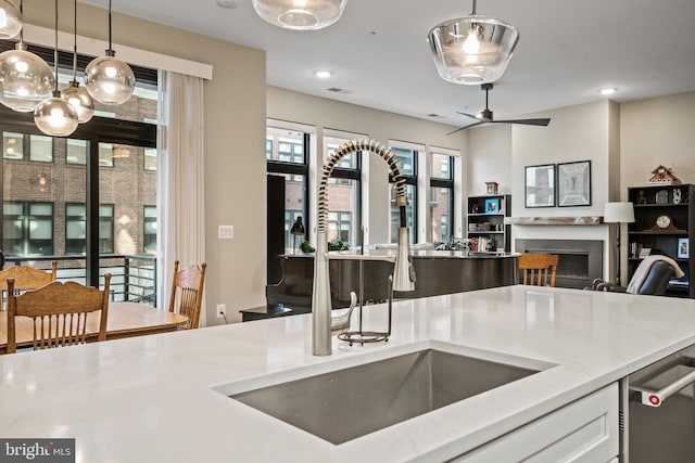 kitchen with white cabinetry, dishwasher, pendant lighting, and sink