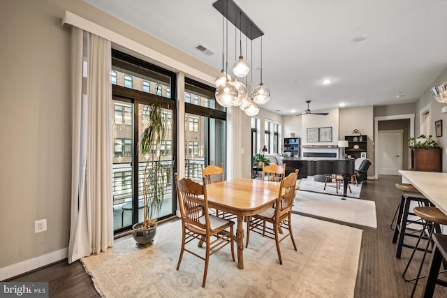 dining room with hardwood / wood-style flooring and ceiling fan