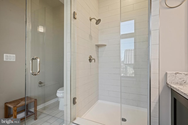 bathroom with toilet, an enclosed shower, vanity, and tile patterned flooring