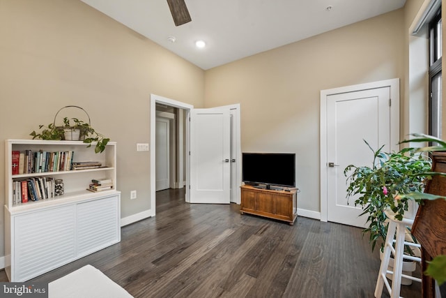 interior space featuring a high ceiling, dark hardwood / wood-style flooring, and ceiling fan