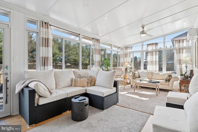 sunroom with vaulted ceiling and a ceiling fan