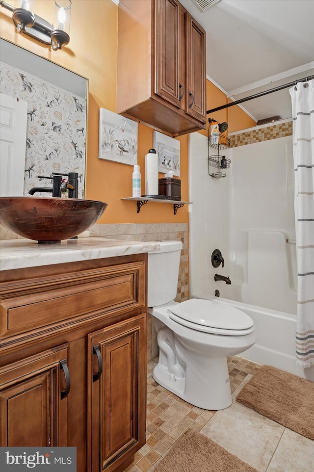 bathroom with toilet, tile patterned flooring, shower / bath combination with curtain, and vanity