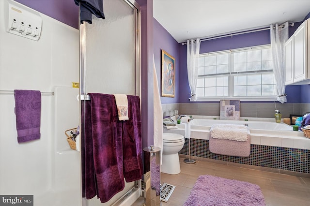 full bathroom featuring toilet, a garden tub, visible vents, and a stall shower