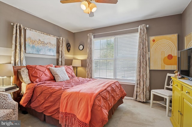 bedroom featuring baseboards, a ceiling fan, and light colored carpet