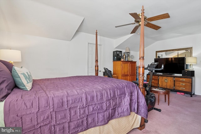 bedroom featuring a ceiling fan, vaulted ceiling, and carpet flooring