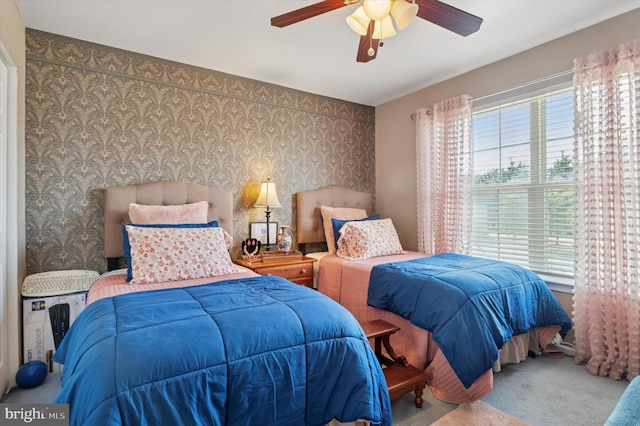 bedroom featuring wallpapered walls, carpet, and a ceiling fan