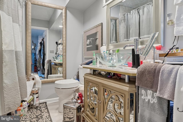 full bathroom featuring vanity, toilet, and tile patterned floors