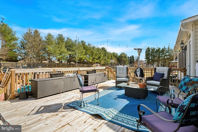 wooden deck with fence and an outdoor living space