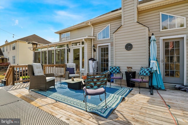 deck with outdoor lounge area and a sunroom