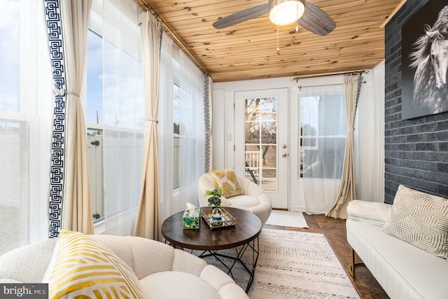 sunroom with ceiling fan, wooden ceiling, and french doors