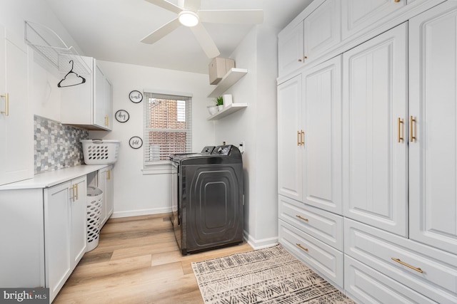 washroom featuring light hardwood / wood-style floors, cabinets, washer / dryer, and ceiling fan