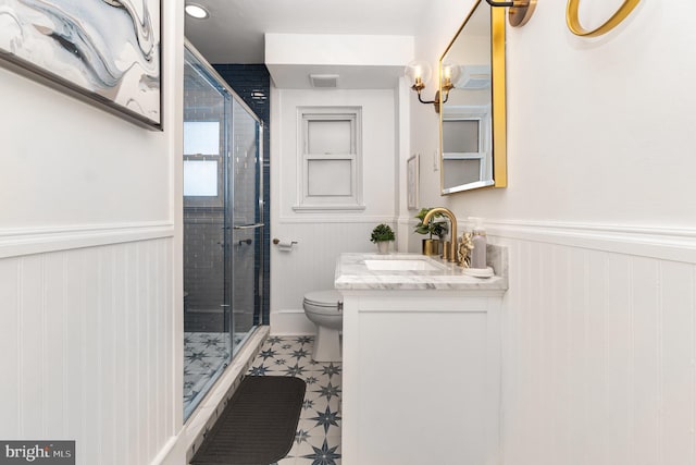 bathroom with toilet, walk in shower, and vanity