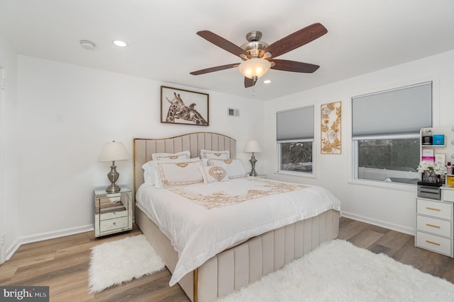 bedroom with ceiling fan and light hardwood / wood-style flooring