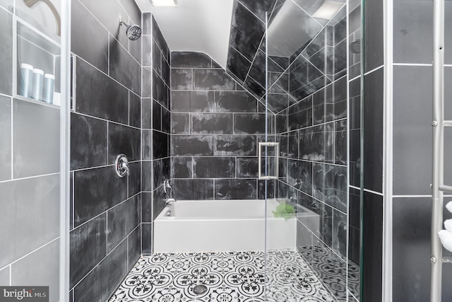 bathroom with tile patterned floors and tiled shower / bath