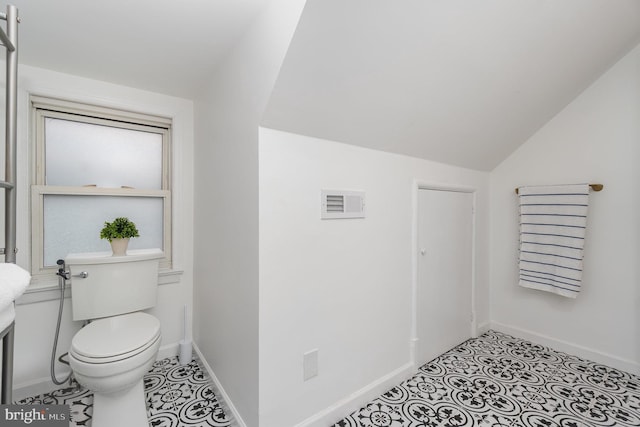 bathroom featuring toilet and vaulted ceiling