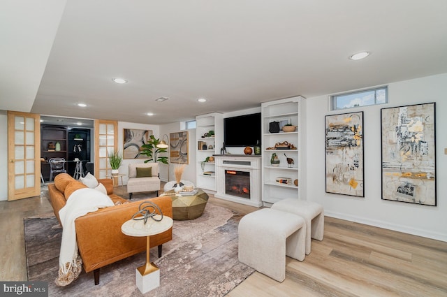 living room featuring light wood-type flooring and french doors