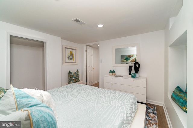 bedroom featuring hardwood / wood-style flooring and a closet