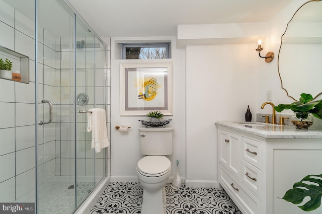 bathroom with a shower with door, toilet, tile patterned floors, and vanity