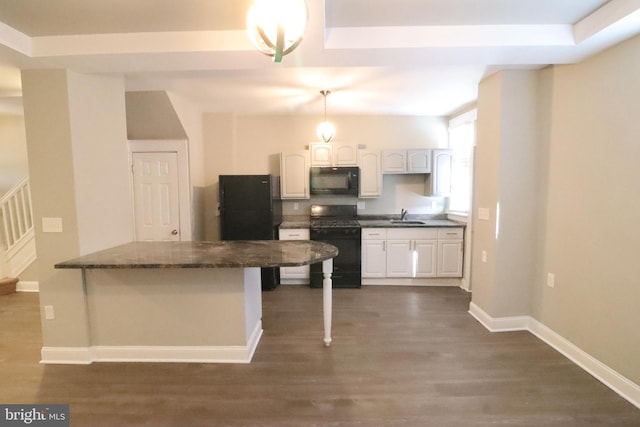 kitchen featuring pendant lighting, black appliances, dark hardwood / wood-style floors, and white cabinets