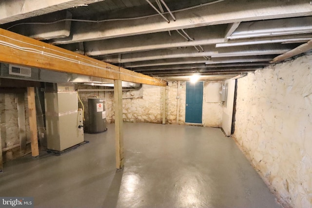 basement featuring water heater and heating unit