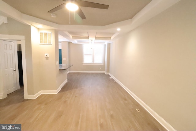 spare room featuring hardwood / wood-style flooring, ceiling fan, and beam ceiling