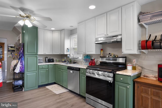 kitchen with light hardwood / wood-style floors, stainless steel appliances, ceiling fan, white cabinets, and sink