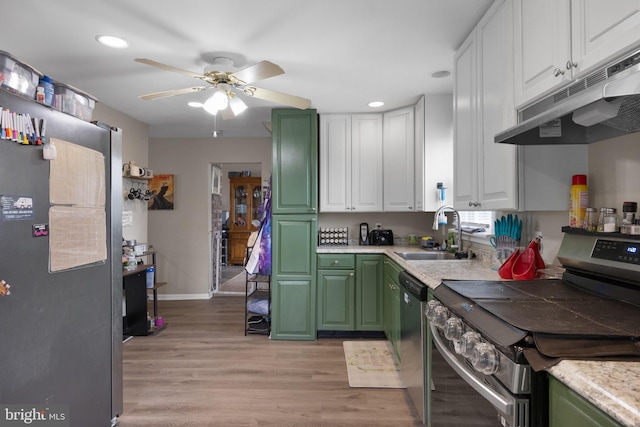 kitchen featuring light hardwood / wood-style flooring, green cabinets, white cabinetry, appliances with stainless steel finishes, and sink