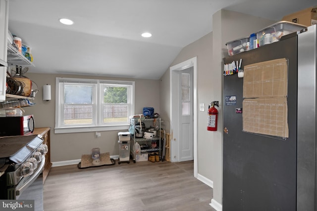 miscellaneous room featuring lofted ceiling and light wood-type flooring