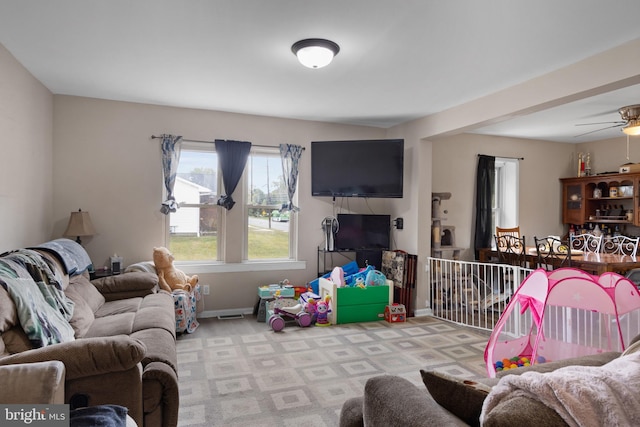 living room with light colored carpet and ceiling fan