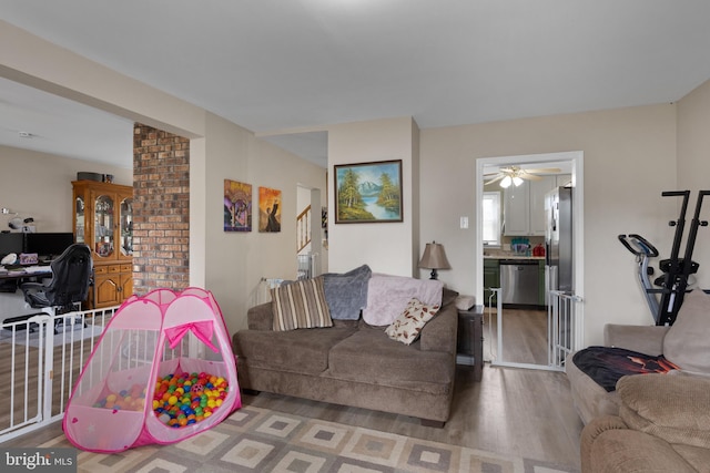 living room featuring wood-type flooring and ceiling fan