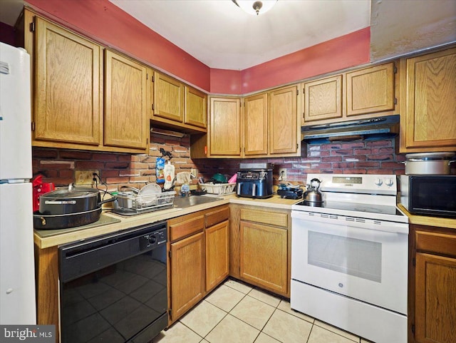 kitchen featuring white appliances, decorative backsplash, and light tile patterned floors