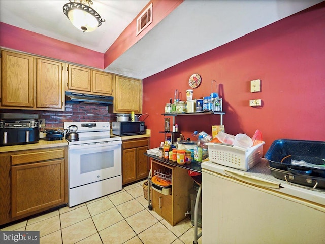 kitchen featuring light tile patterned floors and white electric stove