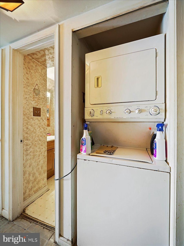 laundry area with stacked washer and clothes dryer