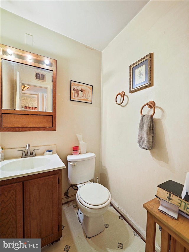 bathroom with toilet and vanity