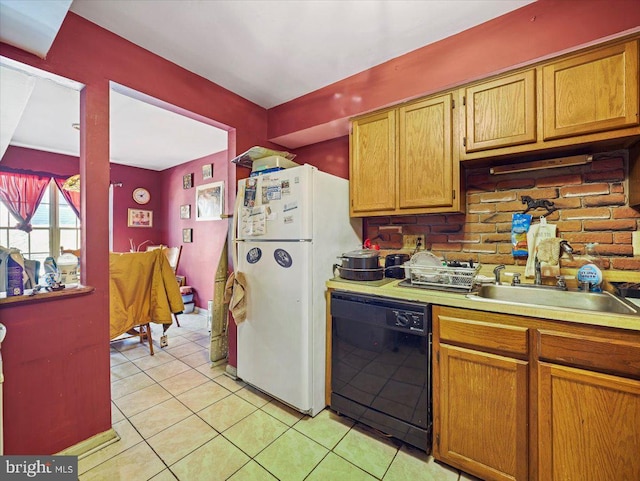 kitchen with white refrigerator, light tile patterned floors, sink, and dishwasher